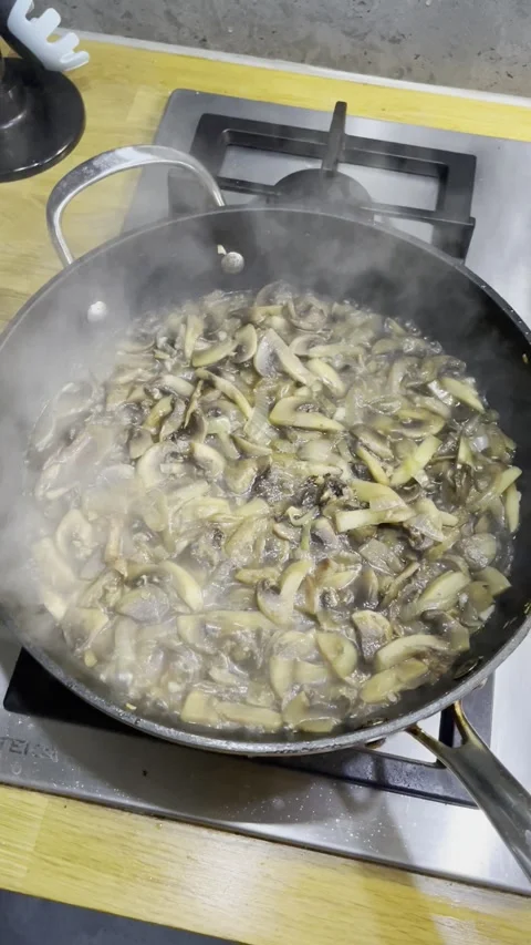 The process of frying champignon mushrooms in a pan Video stock 329422911