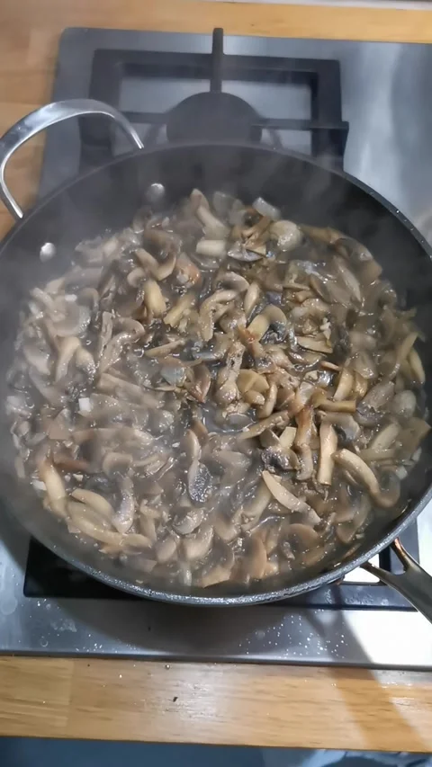 The process of frying champignon mushrooms in a pan Video stock 329423123