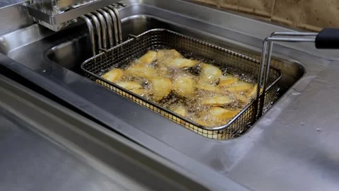 The process of frying chebureks in boiling oil. Pasties with meat fried in Stock Footage 253315247