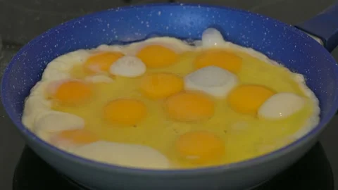 Process of frying eggs in a frying pan on the hob Stock Footage 138316515