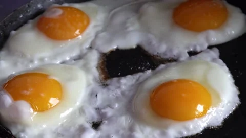 Process of frying eggs in a frying pan Stock Footage 159440752