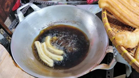 The process of frying fried bread or cakwe. Also known as Youtiao or Cakoi,.. Video stock 330461943