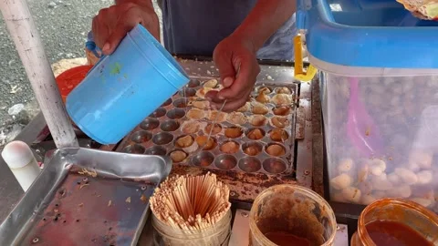 The process of frying fried pentol using processed eggs and potatoes as raw.. Stock Footage 258906360