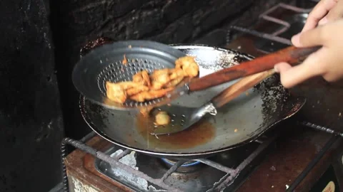The process of frying Gereh or salted fish on a wok with hot cooking oil. Stock Footage 276674014