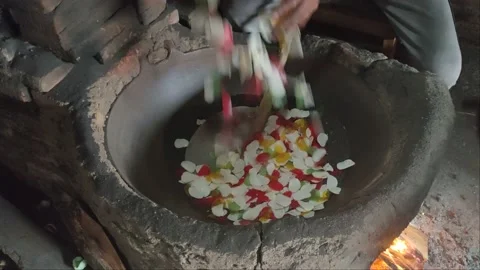 Process of frying Indonesian crackers using river sand in a wok Stock Footage 211809508