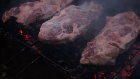 The process of frying meat on the grill in the evening Video stock 76441226