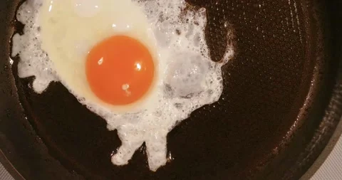 Process of frying one chicken egg, the middle stage Stock Footage 142657697