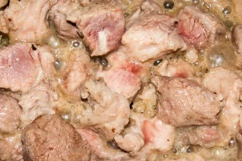 The process of frying pork .Background of roast pork. Stock Photos