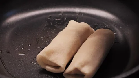 Process of frying stuffed crepes on pan close up shot. Stock Footage 302908476