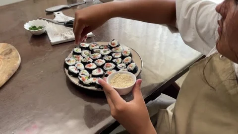 Process of garnishing sushi rolls, artistry involved in creating visually Stock Footage 280985144
