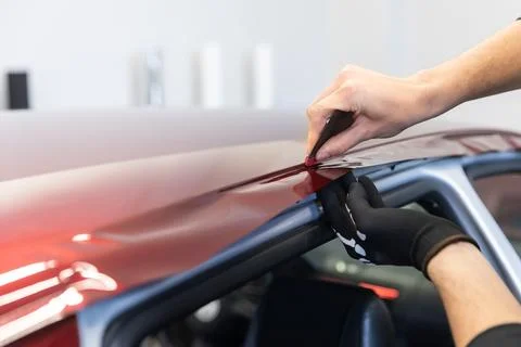 Process of gluing or wrapping a new foil wrap to a car, car detailing concept Stock Photos