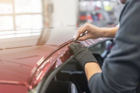 Process of gluing or wrapping a new foil wrap to a car, car detailing concept Stock Photos