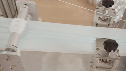 Process of gluing tab for fixing the nose in multi-layer medical mask for Stock Footage 204038655