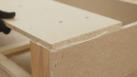 The process of gluing two chipboards Stock Footage 274393092