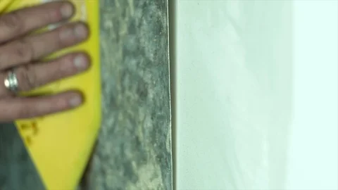 The process of gluing wallpaper on the wall Stock Footage 106466655