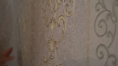 The process of gluing Wallpaper on the wall,the hand of the worker is smooth Stock Footage 79596120