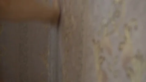 The process of gluing Wallpaper on the wall,the hand of the worker is smooth Stock Footage 79596421