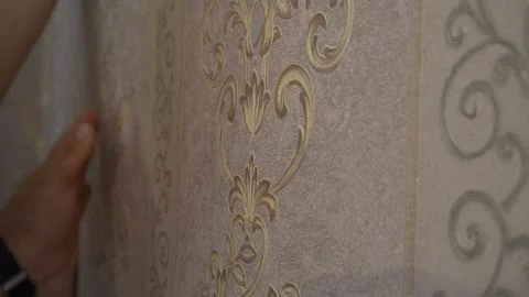 The process of gluing Wallpaper on the wall,the hand of the worker is smooth  Stock Photos