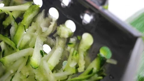 Process of grate green big zucchini or cucumber on the silver grater, preparing  Stock Footage 150562030