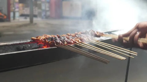 The process of grilling chicken satay Stock Footage 323364872