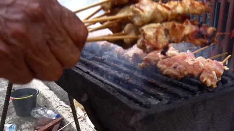 The process of grilling fresh chicken satay with natural fire Stock Footage 243437563