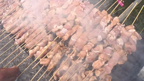 The process of grilling fresh chicken satay with natural fire Stock Footage 243437578