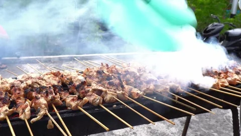 The process of grilling fresh chicken satay with natural fire Stock Footage 243437682