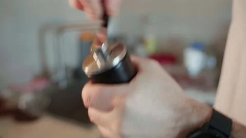 The process of grinding coffee beans in a manual coffee grinder, close-up. Stock Footage 234899222