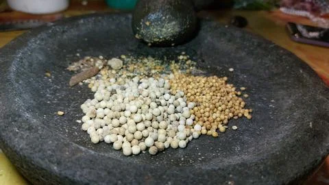 The process of grinding kitchen spices using stone grinder Foto stock