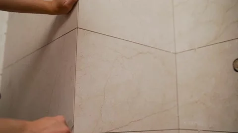 The process of grouting the joint between tiles in the bathroom. Stock Footage 137953843