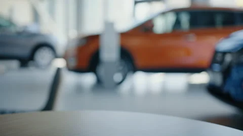 Process of handing over the key to a new car background of the showroom Stock Footage 203768042