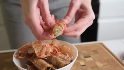 Process of hands peels shrimps shell. Woman cleaning shrimps for cooking Stock Footage 149694556