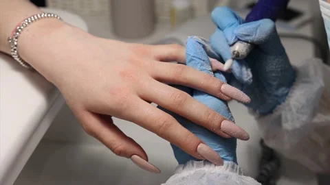 The process of hardware manicure in the salon, removing gel polish or acrylic Stock Footage 148409777