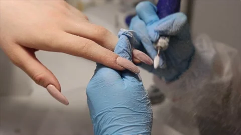 The process of hardware manicure in the salon, removing gel polish or acrylic Stock Footage 148498778