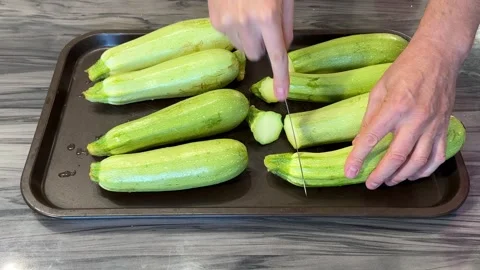 The process of harvesting and preparing zucchinis, showcasing washing, choppi Stock Footage 301864572