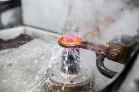 The process of heating and cooling a metal part. Stock Photos