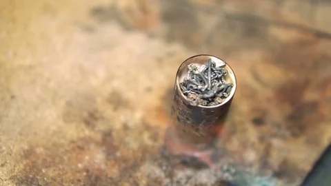 Process heating the silver in a stand with a soldering iron Stock-Footage 72964287