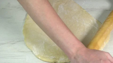 Process of homemade bake with wheat flour. The cook uses a rolling pin to Video stock 241460683