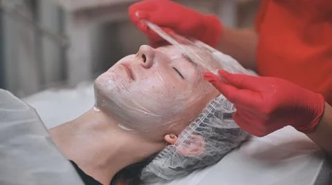 The process of hydrating problem skin with a plastic film. Stock Photos
