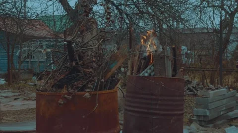 The process of igniting garbage, igniting a barrel of gasoline Stock Footage 321878662