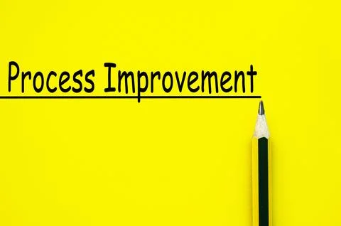 Process improvement text written on yellow paper background. Business impro.. Foto stock