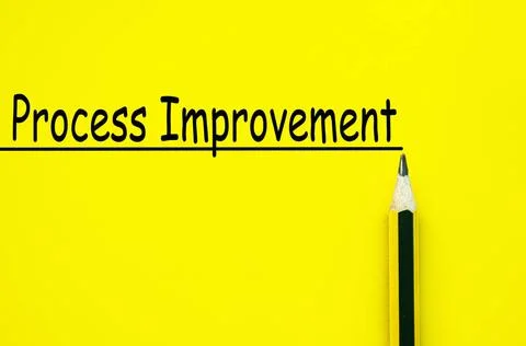 Process improvement text written on yellow paper background. Business impr... Stock Photos