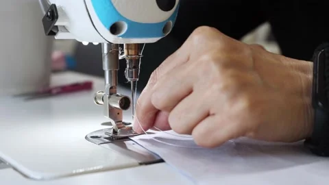 Process of inserting thread into needle of industrial sewing machine. Stock Footage 166690046