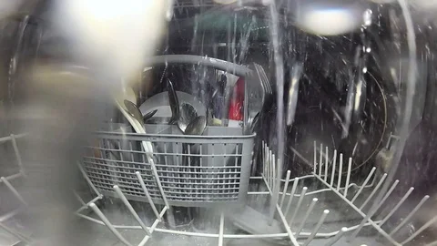 The process inside the dishwasher. Inside view of a dishwasher. Slow motion. Stock Footage 125550147
