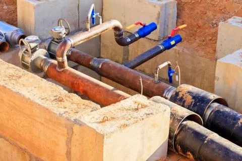 The process of installation of the distribution unit heating network. Stock Photos