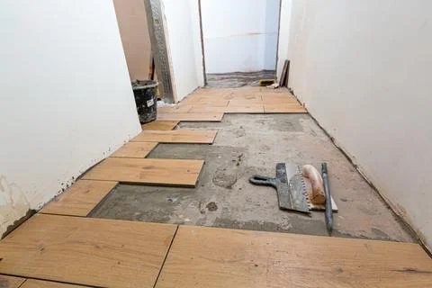 Process of installation of parquet tiles or laminate in apartment is under Stock Photos