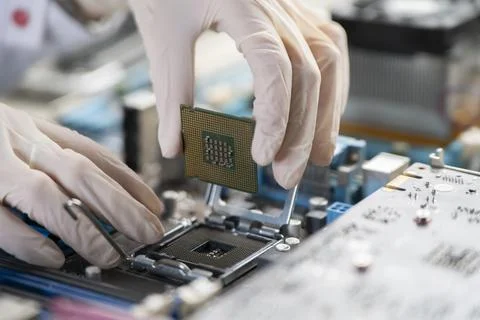 The process of Installation of processor in CPU socket, hands in gloves holding 스톡 사진