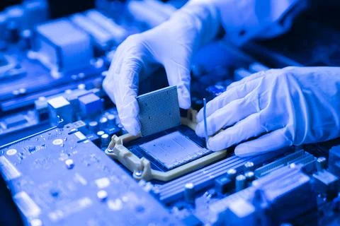 The process of Installation of processor in CPU socket, hands in gloves holding 스톡 사진