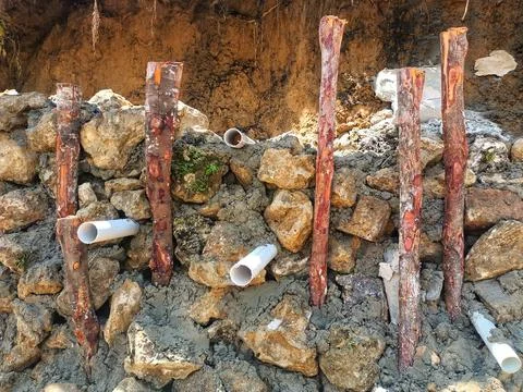 The process of installing a concrete stone foundation. Stock Photos