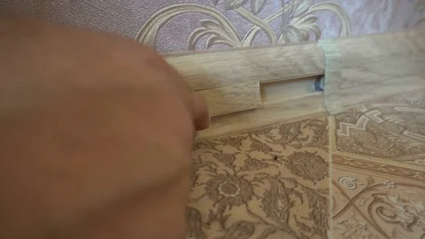 The process of installing the floor, a worker installs the insert into the Stock Footage 79600511